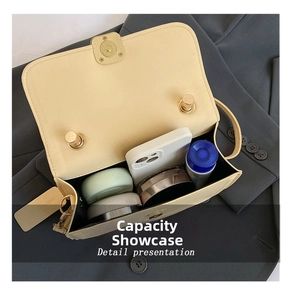 Detail view of cream handbag interior capacity showing space for phone and makeup