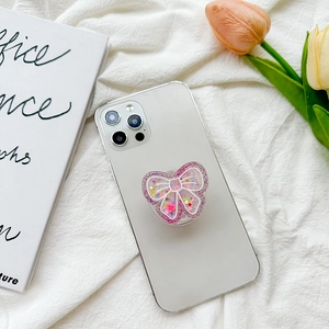 Pink glitter butterfly phone grip holder with Hug Me heart on white fabric background