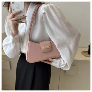 Detaillierte Nahaufnahme der rosa Baguette-Tasche mit goldener Schnalle und glatter Textur