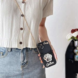Crossbody phone case with cat paw rhinestone and gold chain strap on model