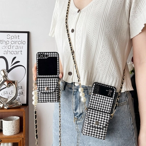 Houndstooth wallet phone case for Samsung Z Flip with pearl crossbody strap worn by a model