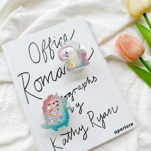 Glitter unicorn and dinosaur pop out phone grips with sequins on white book cover