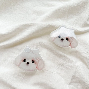 Cute white puppy acrylic phone grip set with bow ties on a soft textured background