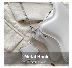 Detail shot of the white star-shaped bag showing silver hardware chain and hook