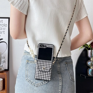 Detail of crossbody chain strap with large pearls on houndstooth phone case for Z Flip