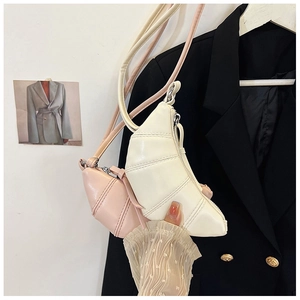 Detail of Korean style pleated croissant bags in cream white and soft pink faux leather