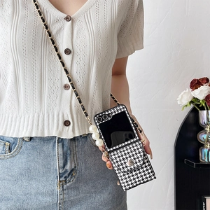 Detail of Samsung Z Flip case with houndstooth pattern and elegant pearl chain strap