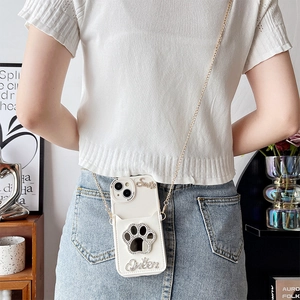 Crossbody iPhone case featuring sparkly rhinestone cat paw design and long gold chain strap