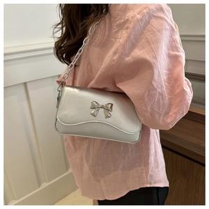 Silver metallic crossbody bag with chunky chain strap and butterfly bow detail