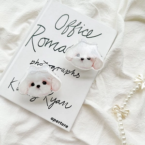 Detail of cute Maltese dog phone socket with bow and glossy acrylic finish