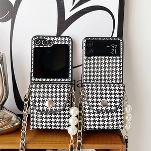 Detail of Galaxy Z Flip case with houndstooth pattern, pearl strap, and metal chain