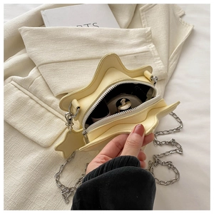 Close-up of star-shaped crossbody bag interior showing storage capacity and silver chain