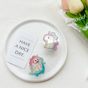 Detail of glitter unicorn and dinosaur phone sockets with sparkling sequins inside