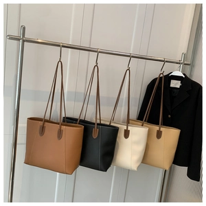 Detailed display of tote bags in four classic colors with elegant long shoulder straps