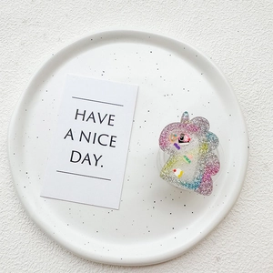 Close-up of a glittery unicorn phone grip with colorful sequins and liquid fillers
