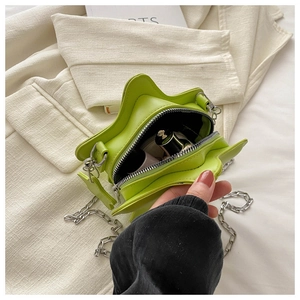 Detailed view of neon green star crossbody bag interior showing storage for cosmetics