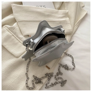 Detailed interior of a star-shaped silver chain bag showing space for cosmetics