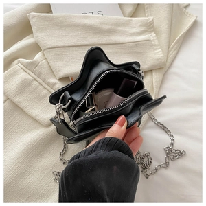 Internal view of star-shaped chain bag showing storage capacity for lipstick and compact