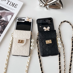 Quilted Z Flip phone case with butterfly decor, pearl strap, and crossbody chain link
