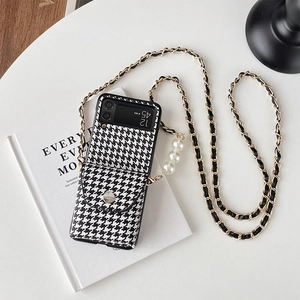Detail of Galaxy Z Flip case with houndstooth pattern, pearl charms and crossbody chain