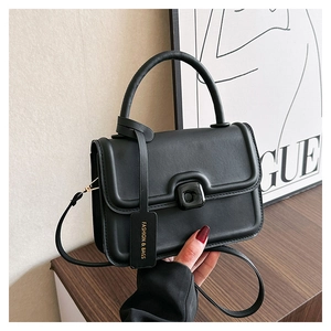 Detail showing the black flap handbag with round handle and Fashion & Bags tag