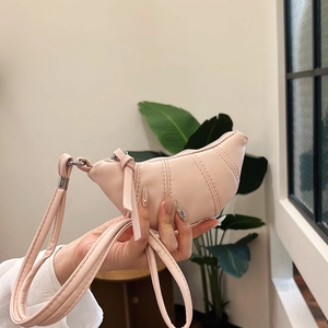 Quilted cherry blossom pink croissant bag with a soft crescent silhouette and shoulder strap