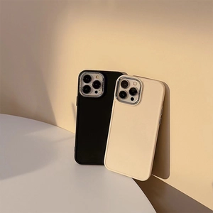 Detail view of premium silicone phone cases in black and beige with camera lens protection