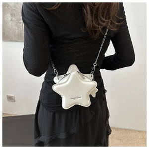 Star-shaped white leather shoulder bag with silver chain strap shown on a model