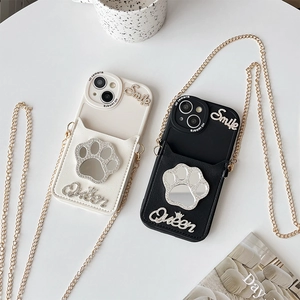 Close-up of leather phone case with rhinestone cat paw mirror and gold crossbody chain