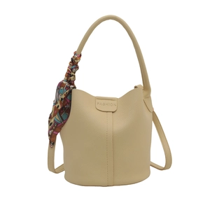 Chic beige lychee leather bucket bag with a decorative floral scarf and top handle