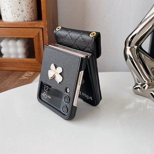 Detail of Galaxy Z Flip4 case with black litchi leather and clover hardware