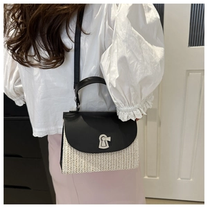 Detail of contrast weave small square bag with leather lid and vintage metal lock