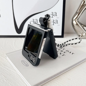 Detail of Galaxy Z Flip case featuring houndstooth strap and durable black textured finish