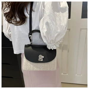 Detail of white woven straw bag with black leather flap and silver keyhole lock