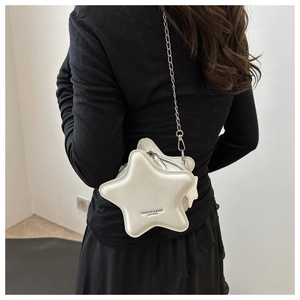 Detail of white star-shaped crossbody bag with silver chain strap and fashion logo