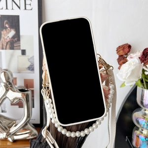 Detail of off-white iPhone case with faux pearl handle and detachable crossbody strap