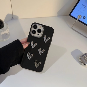 Detailed view of black silicone iPhone case featuring 3D silver lava heart decorations