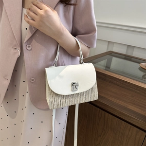 Elegant woven straw and white leather crossbody bag with silver geometric clasp