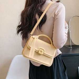 Minimalist cream yellow crossbody bag for women with flap cover and metallic lock