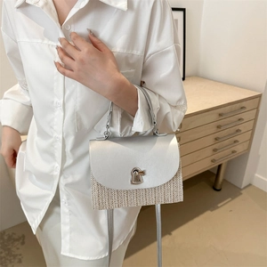 Silver textured woven crossbody bag with metallic lid and stylish lock buckle closure
