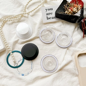 Flat lay of magnetic air bag phone holders with 3M adhesive pads on white linen