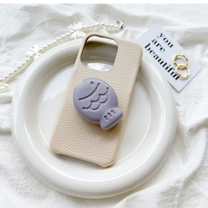 Cream lychee leather phone case featuring a 3D purple cartoon fish pop socket stand