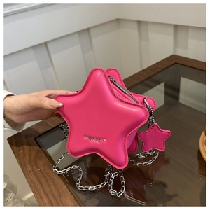 Detail of pink star-shaped crossbody bag with silver chain strap and fashion logo
