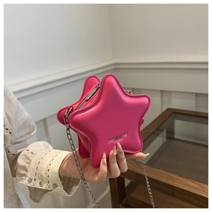 Detail of fuchsia star-shaped faux leather bag with silver chain and white logo text