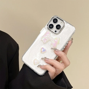 White glitter iPhone case featuring 3D pearl bow and heart accents in a stylish design