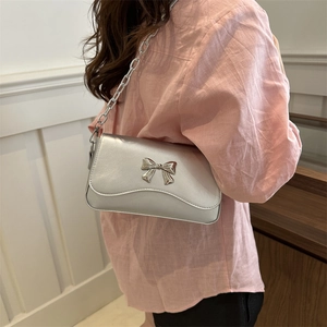 Silver metallic butterfly shoulder bag with chunky chain strap for modern styling