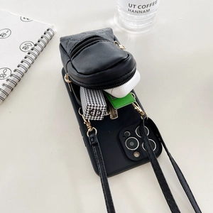 Detail view of a black quilted leather phone case with mini backpack pocket and cross-body strap
