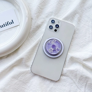 Magnetic purple glitter phone socket with pearl bow and star on white smartphone