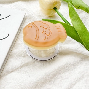Close-up of creative taiyaki fish phone grip with frosted texture on white fabric