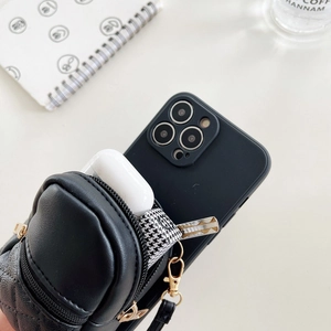 Close-up of black quilted mini bag case for iPhone with gold hardware and zipper detail